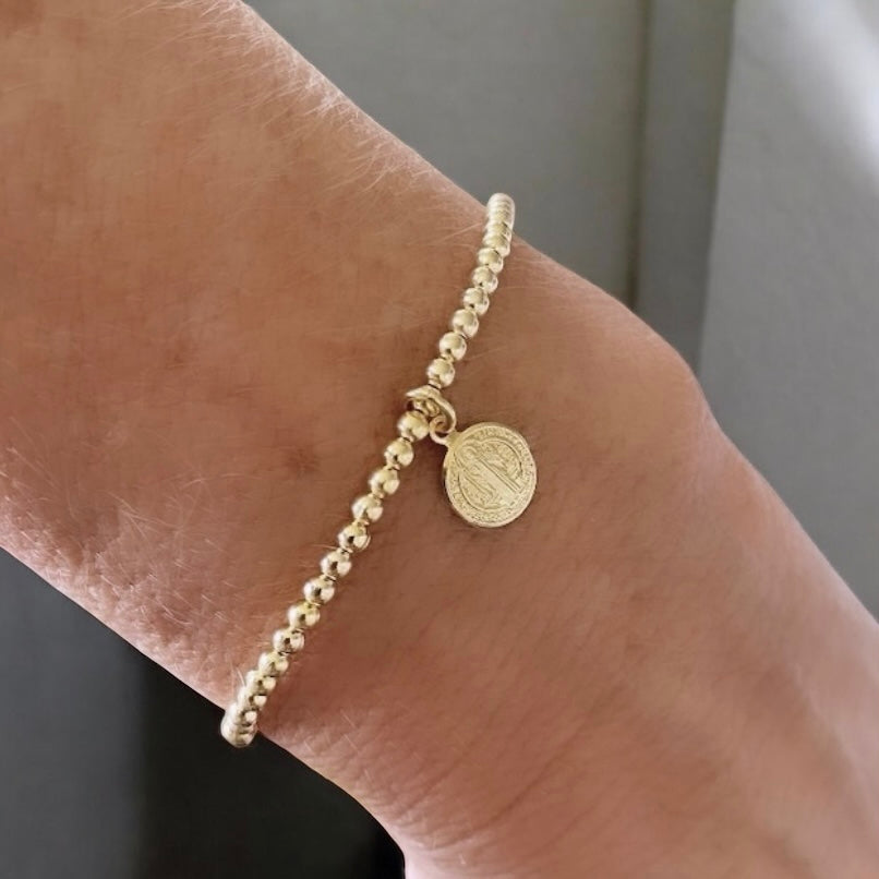 Pulsera bolitas san Benito oro