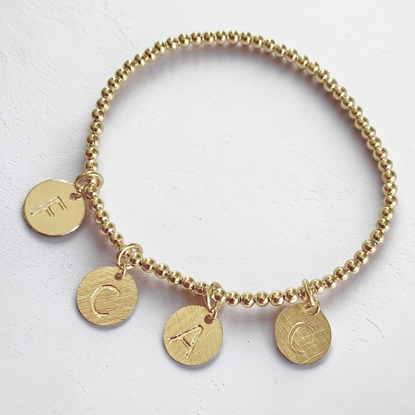 Pulsera letra oro