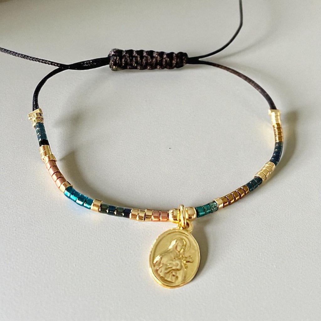 Pulsera hilo Santa Teresita oro