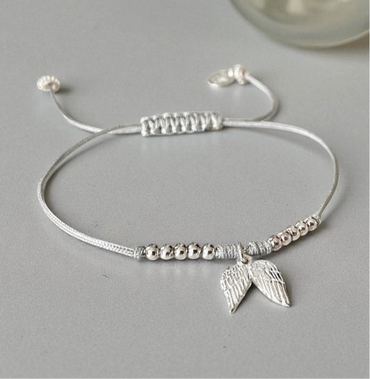 Pulsera hilo gris alitas plata