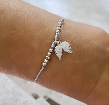 Pulsera hilo gris alitas plata