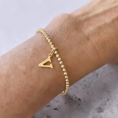 Pulsera bolitas letra oro