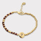 Pulsera granates cruz calada oro