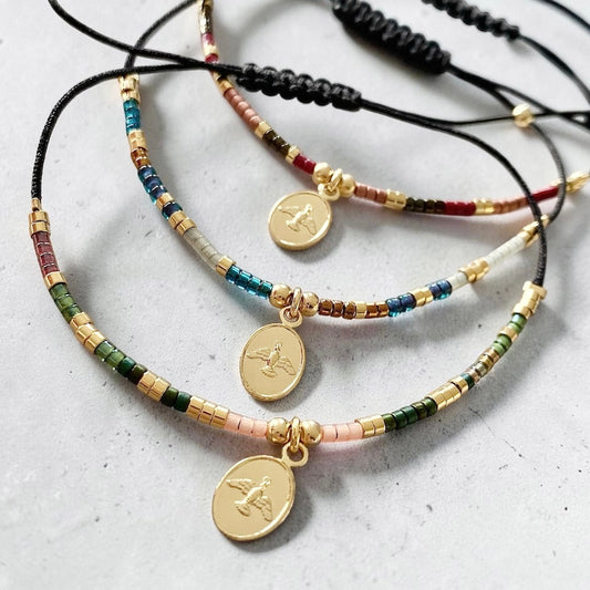 Pulsera hilo mijuki Espíritu Santo oro