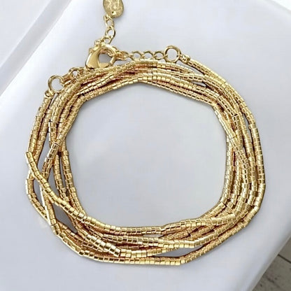 Pulsera mostacillas cinco vueltas oro