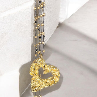 Collar tejido ónix corazón oro