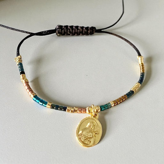 Pulsera hilo Santa Teresita oro