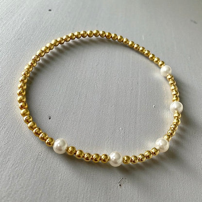 Pulsera cinco perlas oro