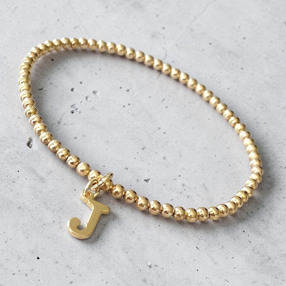 Pulsera bolitas letra oro