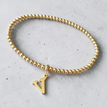 Pulsera bolitas letra oro