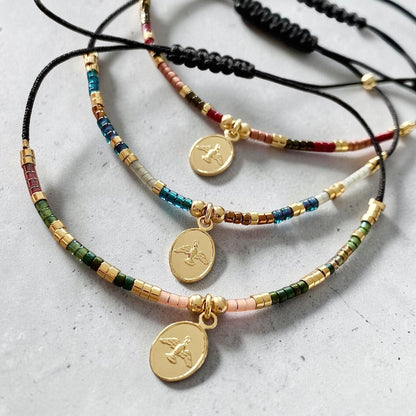 Pulsera hilo mijuki Espíritu Santo oro
