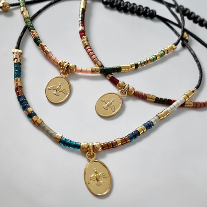 Pulsera hilo mijuki Espíritu Santo oro