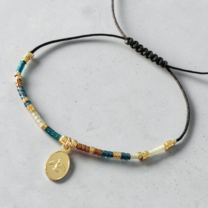 Pulsera hilo mijuki Espíritu Santo oro