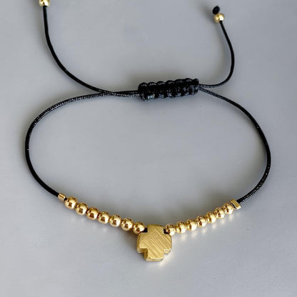 Pulsera hilo cruz oro