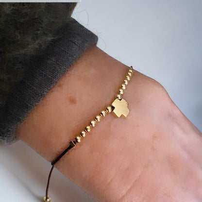 Pulsera hilo cruz oro