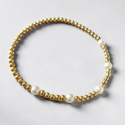Pulsera cinco perlas oro